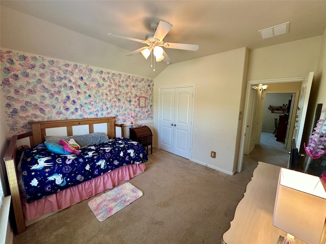 carpeted bedroom with lofted ceiling, ceiling fan, and a closet