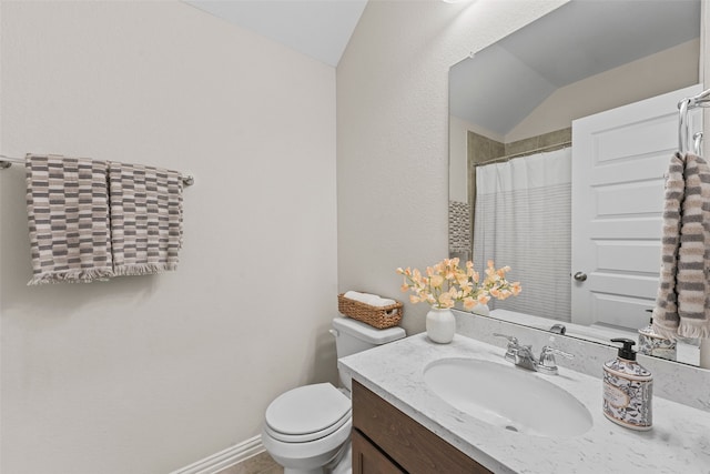 bathroom featuring vanity, lofted ceiling, and toilet