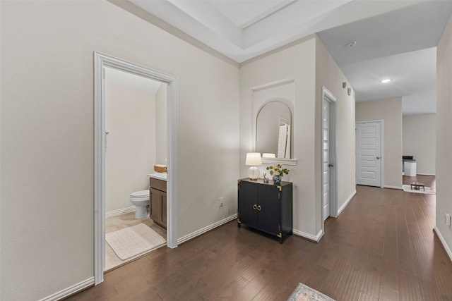 hallway with dark hardwood / wood-style flooring