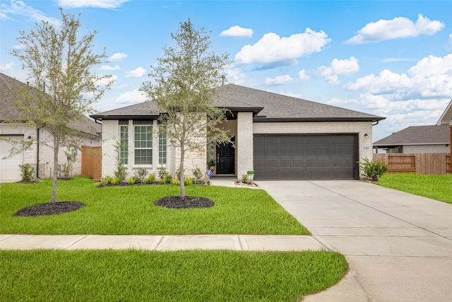 view of front of house featuring a front yard and a garage