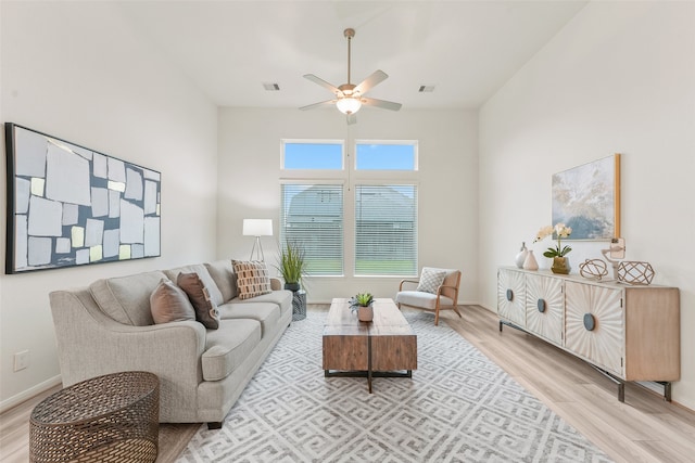 living room featuring light hardwood / wood-style flooring and ceiling fan