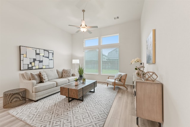 living room featuring ceiling fan and light hardwood / wood-style flooring