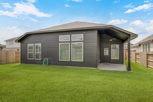 rear view of property featuring a lawn