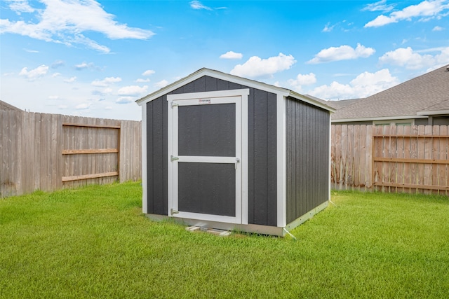 view of outbuilding featuring a lawn