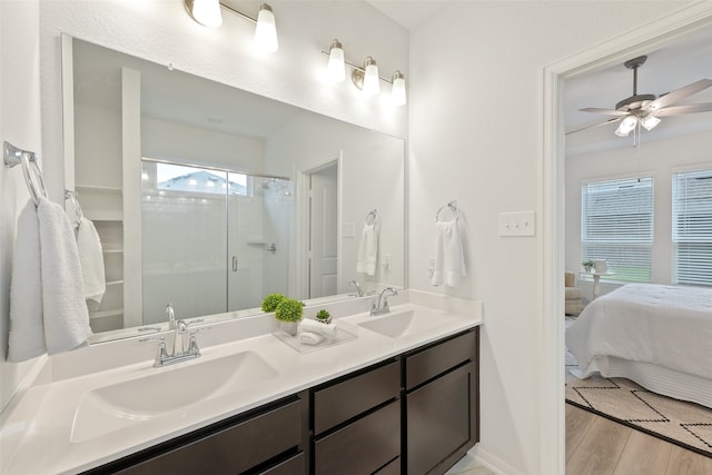 bathroom featuring wood-type flooring, ceiling fan, a shower with door, and a wealth of natural light