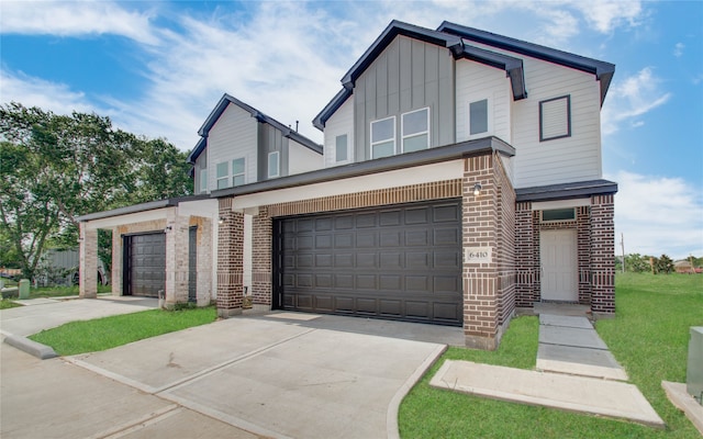 view of front of house with a front yard and a garage