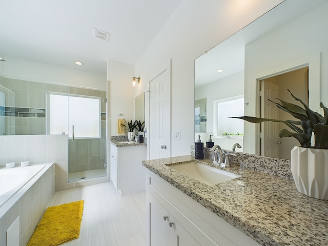 bathroom with vanity and plus walk in shower