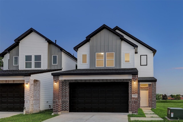 view of front of house with a garage and a yard