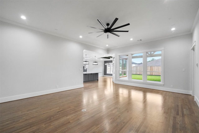 unfurnished living room featuring ceiling fan, dark hardwood / wood-style flooring, and crown molding