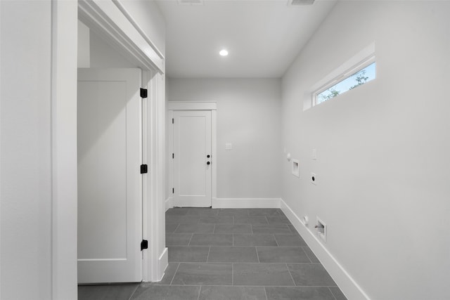 clothes washing area featuring washer hookup, electric dryer hookup, and dark tile patterned floors