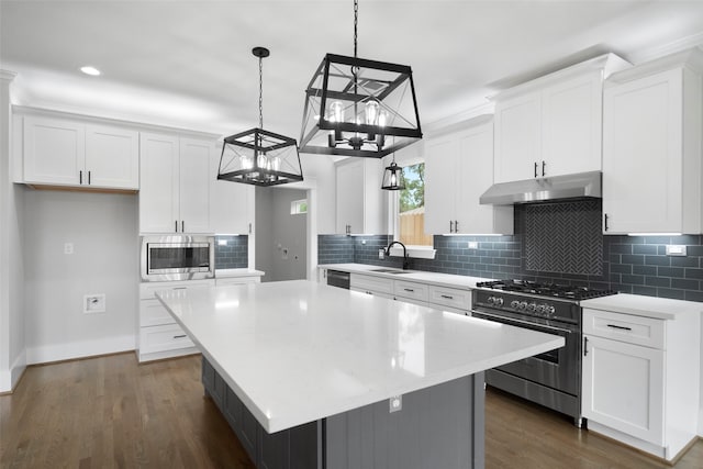 kitchen with a kitchen island, white cabinetry, and appliances with stainless steel finishes