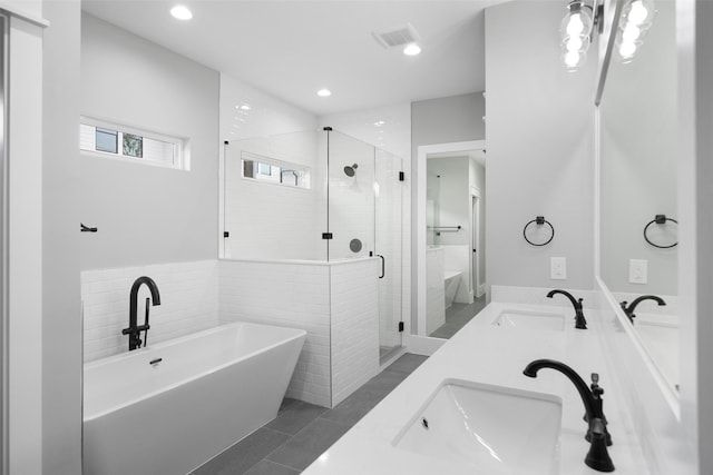 bathroom featuring separate shower and tub, tile patterned flooring, and vanity