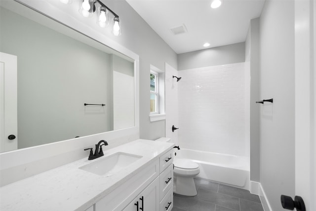 full bathroom with tile patterned floors, vanity, tiled shower / bath combo, and toilet