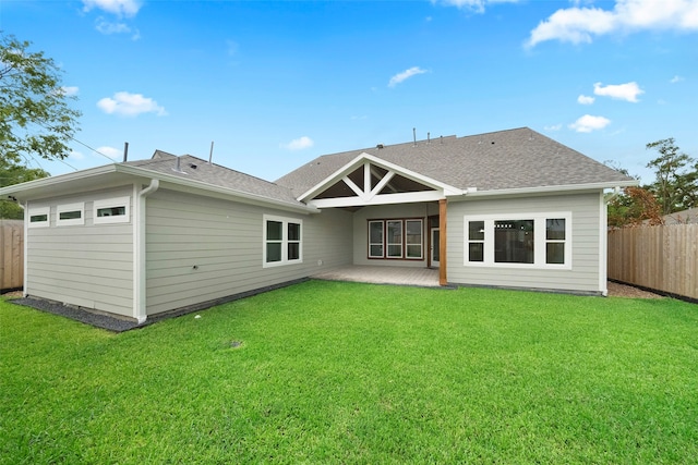 rear view of property with a lawn and a patio