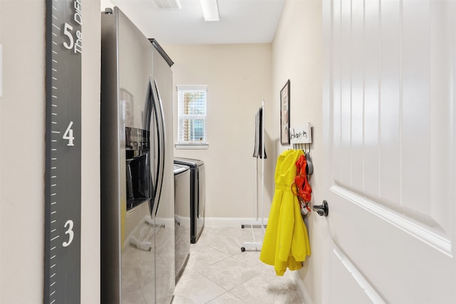 clothes washing area featuring independent washer and dryer and light tile patterned floors