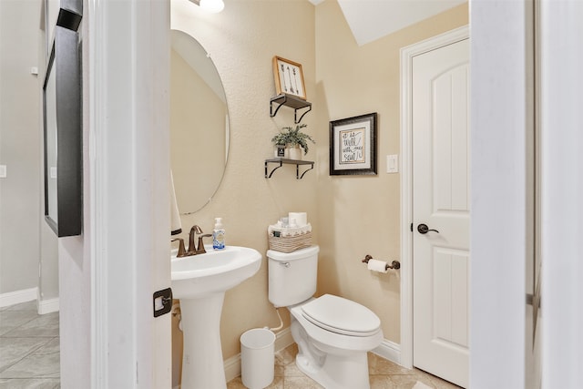 bathroom with toilet and tile patterned floors