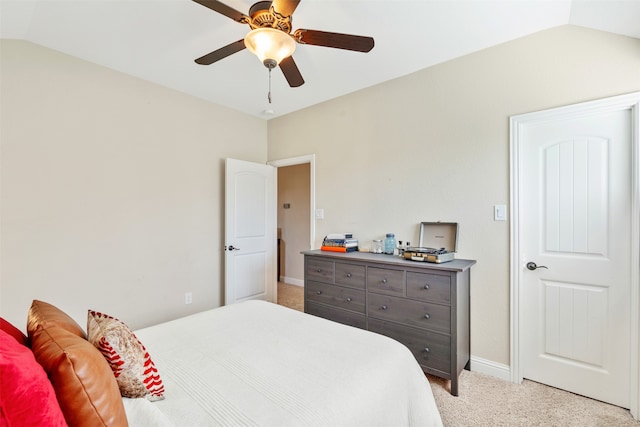 bedroom with ceiling fan, lofted ceiling, and light carpet