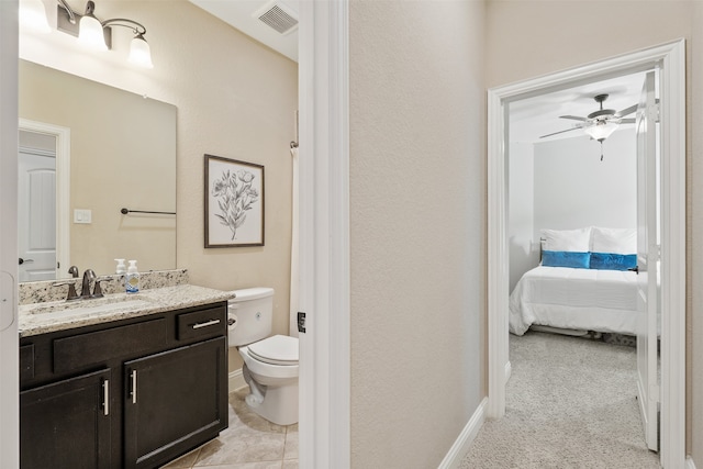 bathroom with vanity, toilet, and ceiling fan