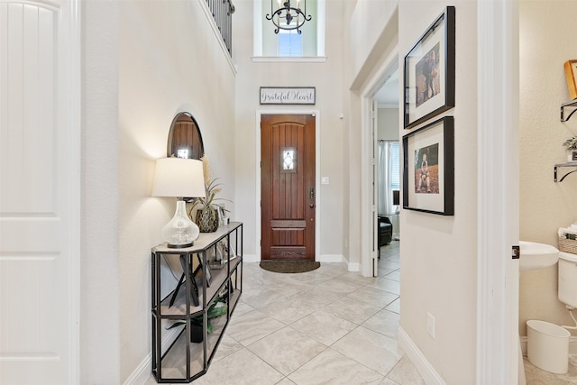 entrance foyer with a notable chandelier and plenty of natural light