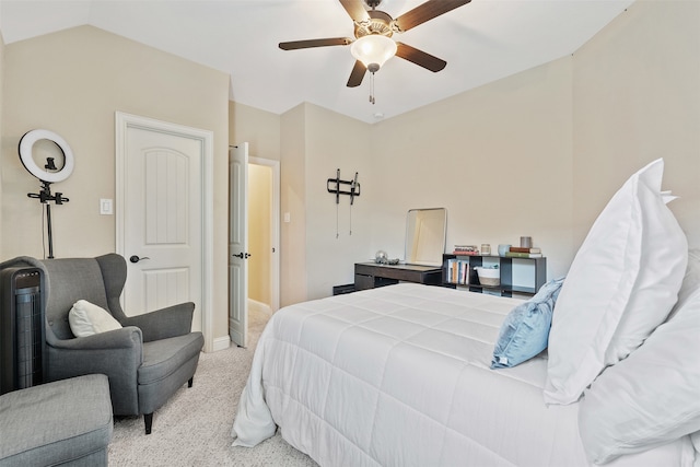 bedroom with light carpet, vaulted ceiling, and ceiling fan