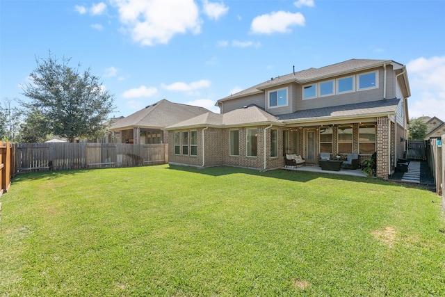 back of property with a lawn, an outdoor living space, ceiling fan, and a patio area