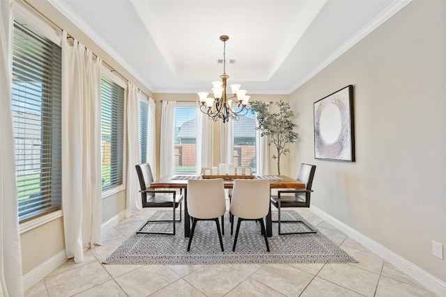 dining area featuring ornamental molding, a chandelier, a raised ceiling, and light tile patterned floors