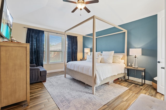 bedroom with ornamental molding, wood-type flooring, and ceiling fan