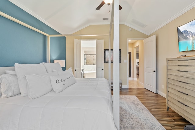 bedroom with vaulted ceiling, ceiling fan, ornamental molding, hardwood / wood-style floors, and ensuite bath