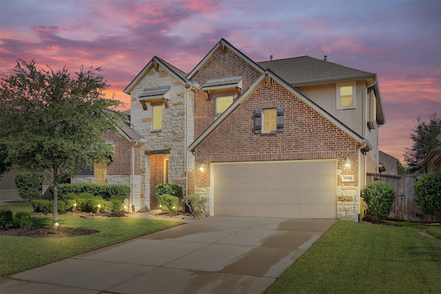 view of front property featuring a yard and a garage