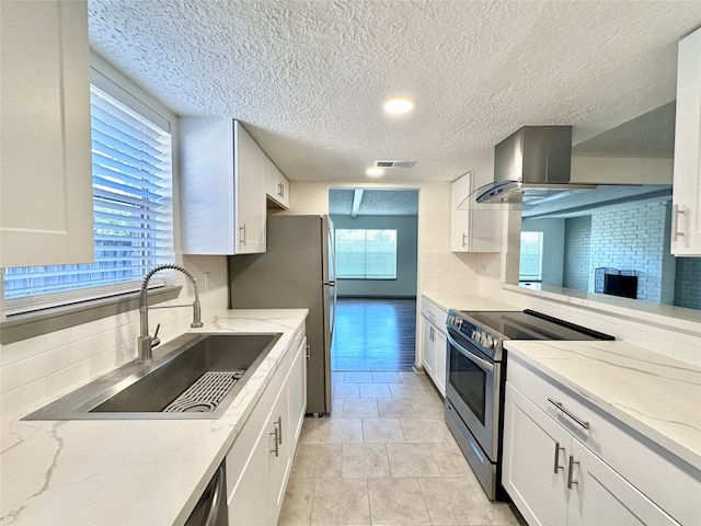 kitchen featuring decorative backsplash, white cabinetry, sink, and stainless steel appliances