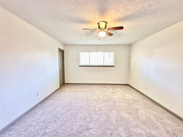 carpeted empty room with a textured ceiling and ceiling fan