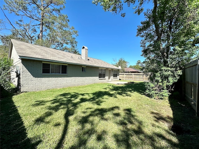 back of property featuring a lawn