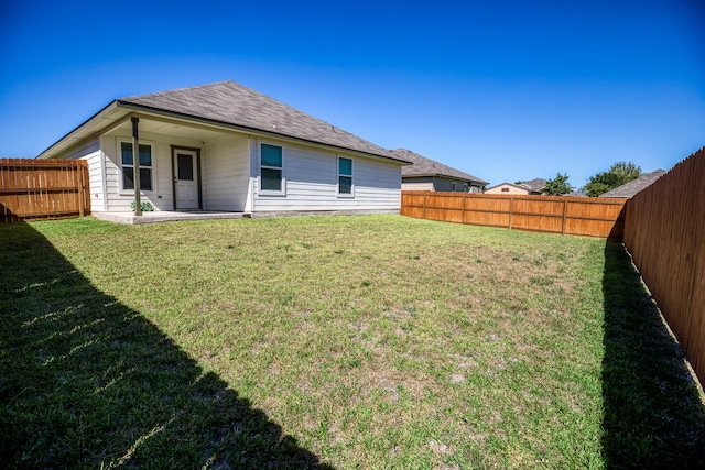 rear view of house with a yard