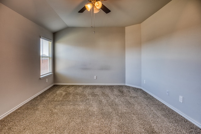 carpeted spare room with ceiling fan and vaulted ceiling