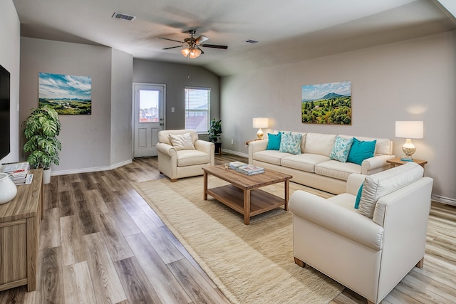 living room featuring light hardwood / wood-style flooring, vaulted ceiling, and ceiling fan