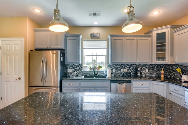 kitchen featuring appliances with stainless steel finishes, gray cabinetry, sink, and pendant lighting