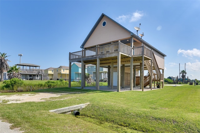 rear view of property with a deck and a yard