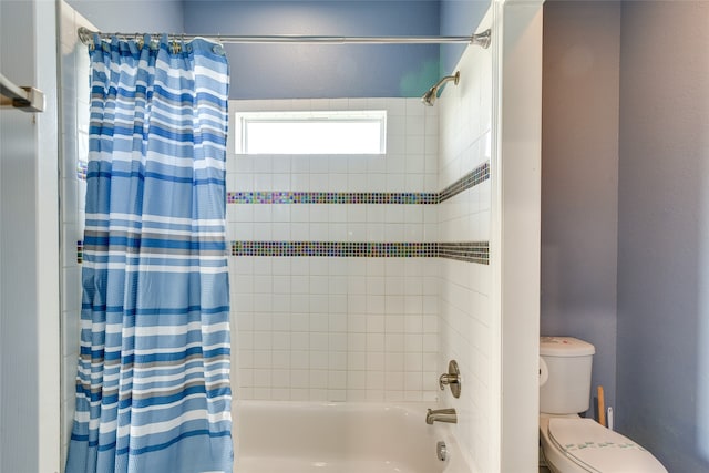 bathroom featuring shower / bathtub combination with curtain and toilet