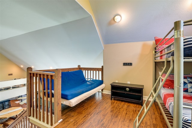 bedroom featuring hardwood / wood-style floors and vaulted ceiling