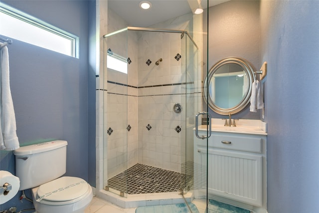 bathroom with vanity, toilet, an enclosed shower, and tile patterned floors