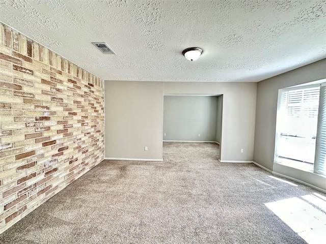 unfurnished room featuring carpet floors and a textured ceiling