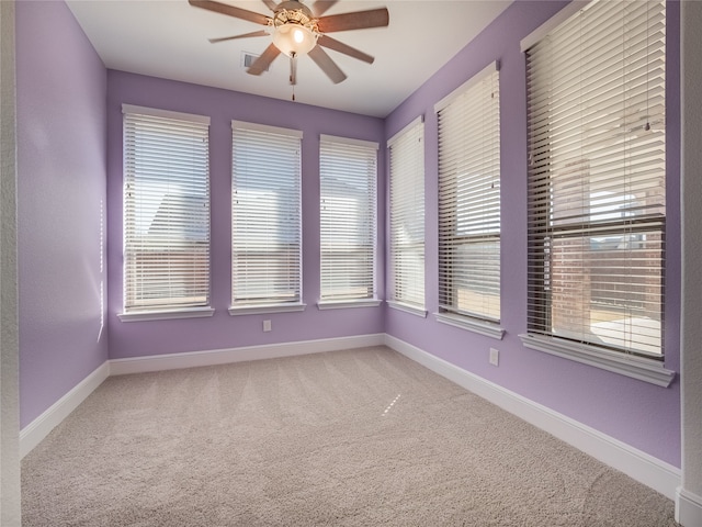 empty room featuring carpet floors and ceiling fan