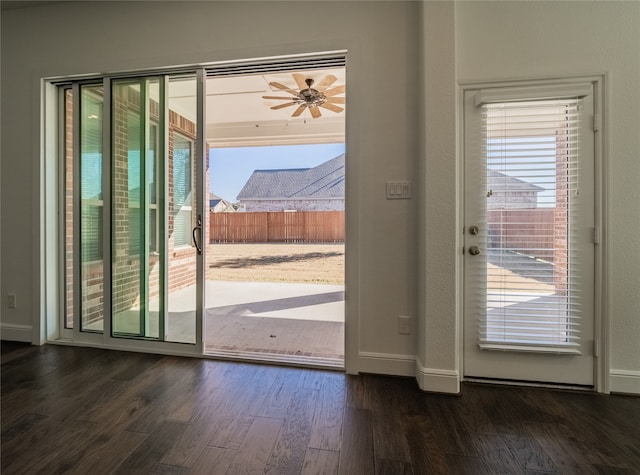 doorway featuring ceiling fan, dark hardwood / wood-style floors, and a healthy amount of sunlight