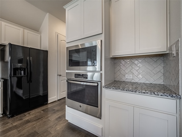 kitchen with appliances with stainless steel finishes, dark wood-type flooring, tasteful backsplash, white cabinets, and dark stone counters