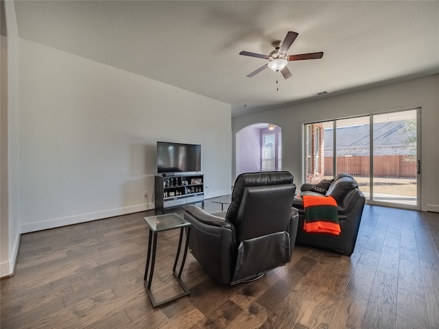 living room featuring dark hardwood / wood-style floors and ceiling fan