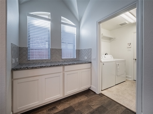 clothes washing area featuring dark hardwood / wood-style flooring and washing machine and clothes dryer