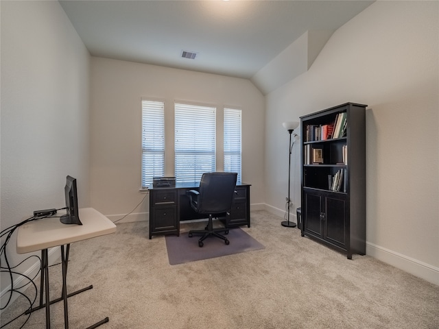 office space featuring vaulted ceiling and light colored carpet