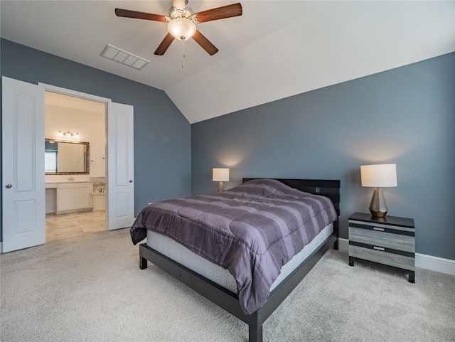 bedroom featuring light carpet, lofted ceiling, connected bathroom, and ceiling fan