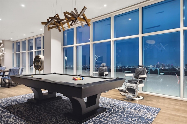 playroom with a wall of windows, wood-type flooring, and pool table