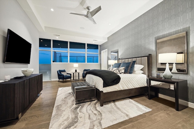 bedroom with hardwood / wood-style floors and ceiling fan